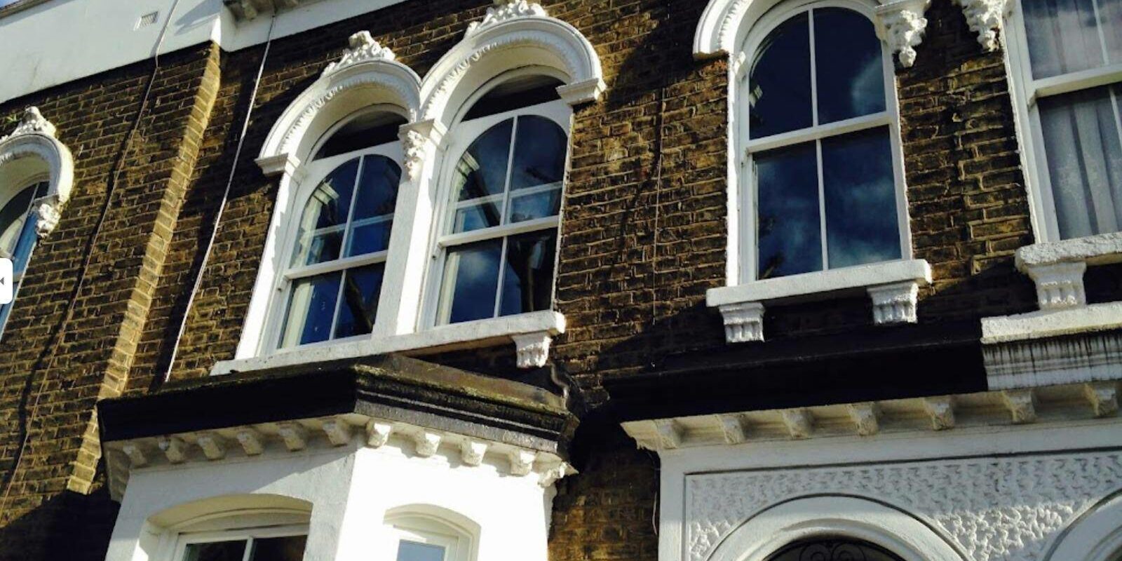 Timber double glazed windows with dummy arches