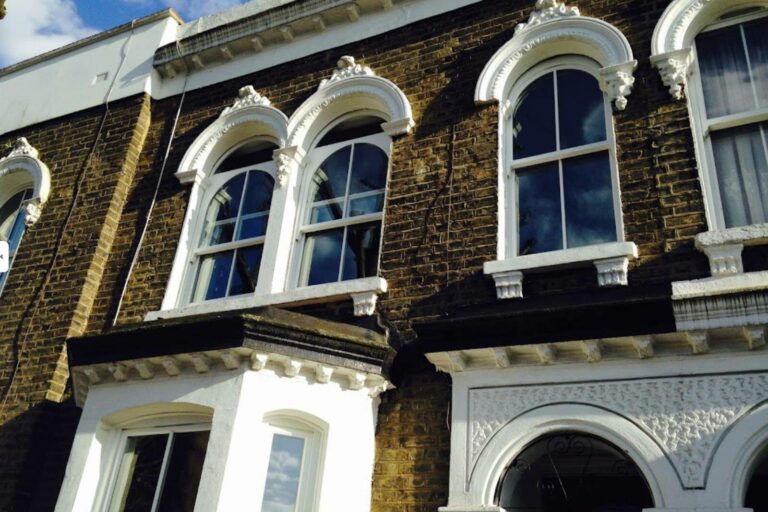 Timber double glazed windows with dummy arches
